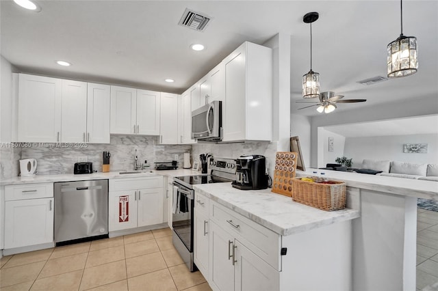 7531 Simms St, Hollywood, FL 33024 - kitchen featuring appliances with stainless steel finishes, a ceiling fan, tasteful backsplash, a sink, and white cabinets