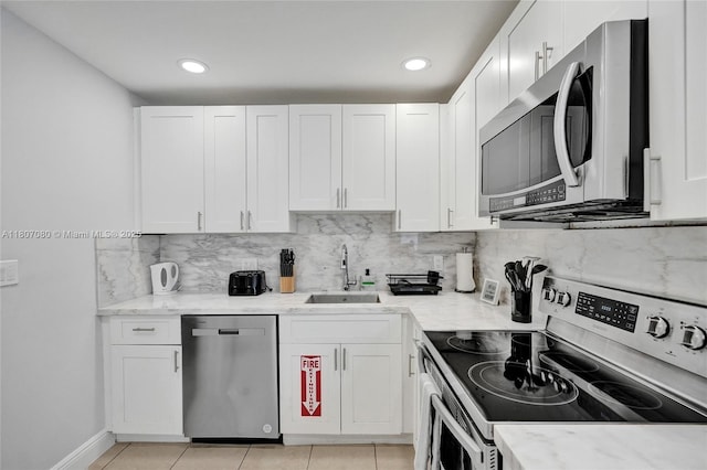 7531 Simms St, Hollywood, FL 33024 - kitchen featuring stainless steel appliances, a sink, tasteful backsplash, white cabinetry, and recessed lighting