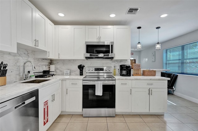 7531 Simms St, Hollywood, FL 33024 - kitchen featuring appliances with stainless steel finishes, a sink, tasteful backsplash, white cabinets, and recessed lighting