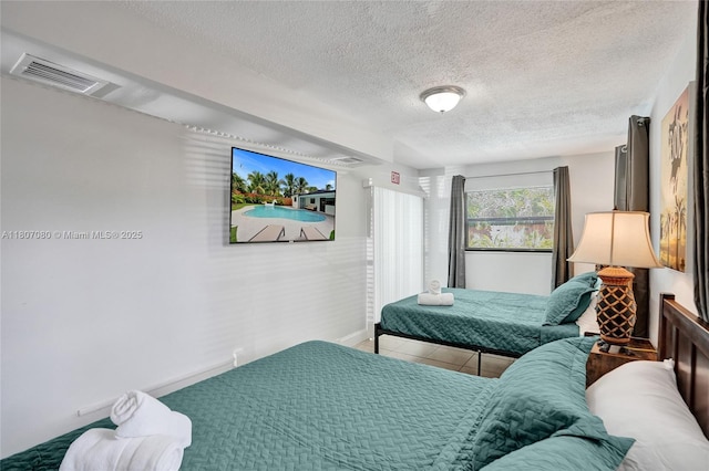 7531 Simms St, Hollywood, FL 33024 - bedroom featuring a textured ceiling, baseboards, and tile patterned floors