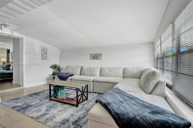 7531 Simms St, Hollywood, FL 33024 - living area with tile patterned floors, vaulted ceiling, and baseboards