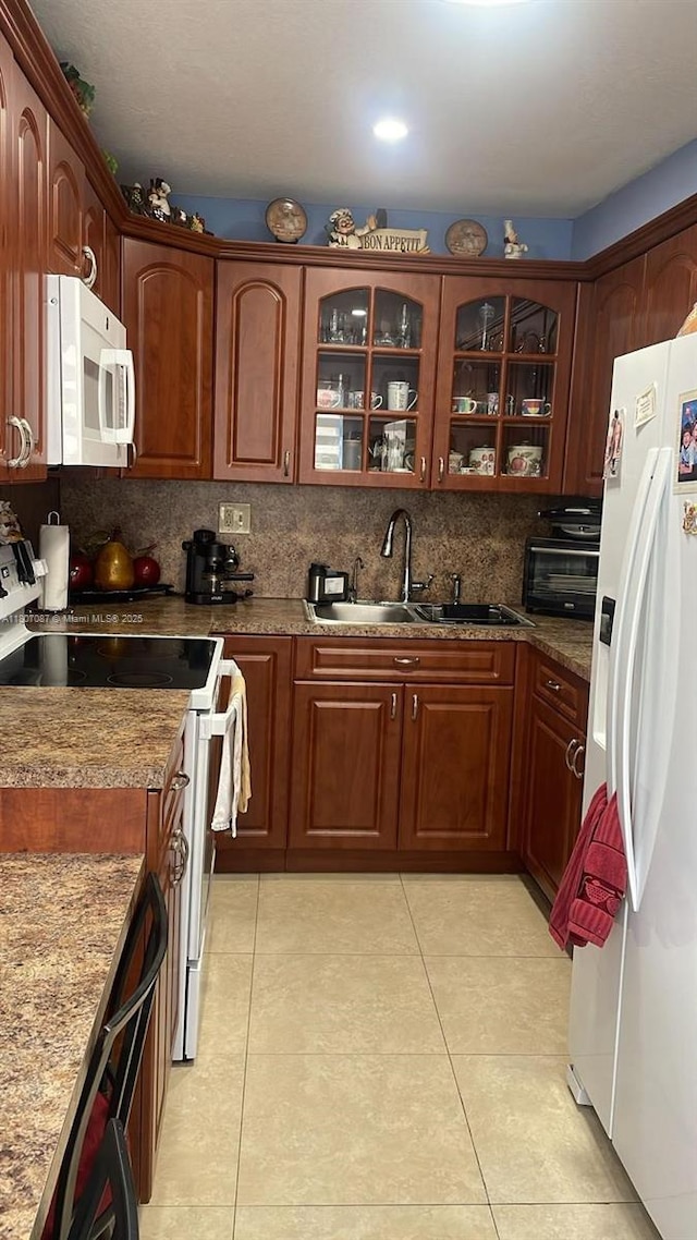 1560 W 46th St Unit 229, Hialeah, FL 33012 - kitchen with white appliances, a sink, light tile patterned floors, and glass insert cabinets