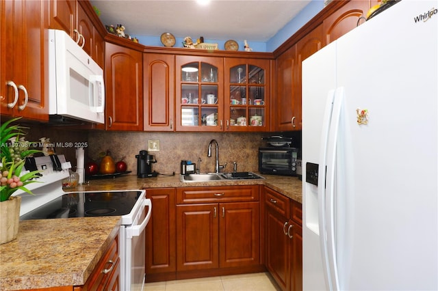 1560 W 46th St Unit 229, Hialeah, FL 33012 - kitchen with white appliances, a sink, tasteful backsplash, glass insert cabinets, and light tile patterned floors