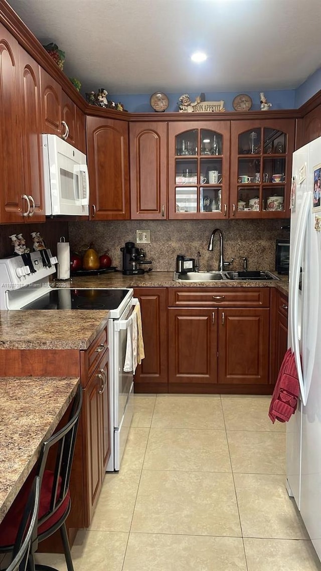 1560 W 46th St Unit 229, Hialeah, FL 33012 - kitchen featuring white appliances, a sink, light tile patterned floors, glass insert cabinets, and tasteful backsplash