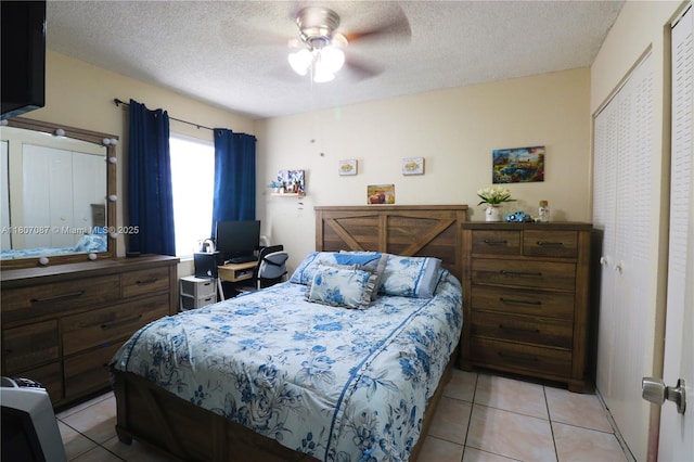 1560 W 46th St Unit 229, Hialeah, FL 33012 - bedroom featuring a textured ceiling, light tile patterned floors, and ceiling fan