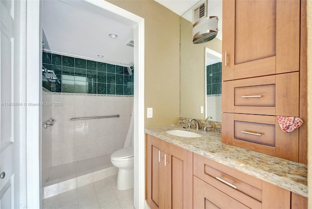 9033 SW 123rd Ct Unit 101, Miami, FL 33186 - full bathroom with a tile shower, vanity, tile patterned flooring, and toilet