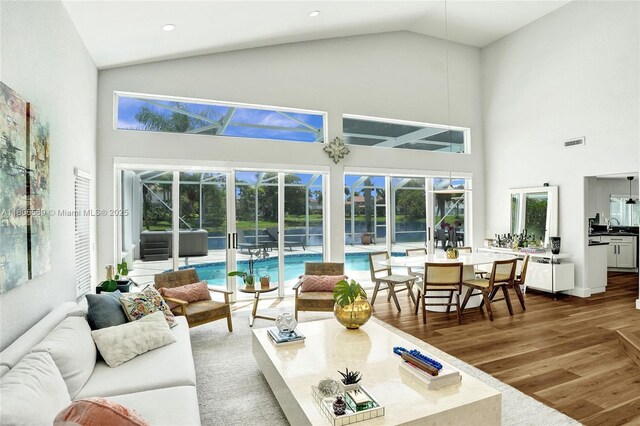 594 Spinnaker, Weston, FL 33326 - living room with high vaulted ceiling, wood finished floors, healthy amount of natural light, and recessed lighting