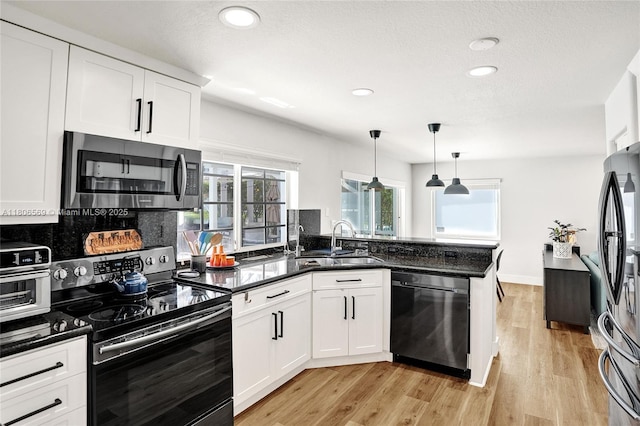 594 Spinnaker, Weston, FL 33326 - kitchen featuring appliances with stainless steel finishes, a sink, white cabinets, recessed lighting, and a peninsula