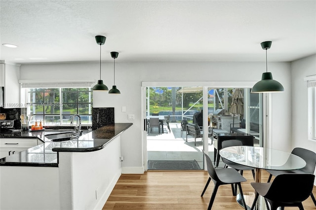 594 Spinnaker, Weston, FL 33326 - kitchen with a sink, dark countertops, white cabinets, plenty of natural light, and recessed lighting