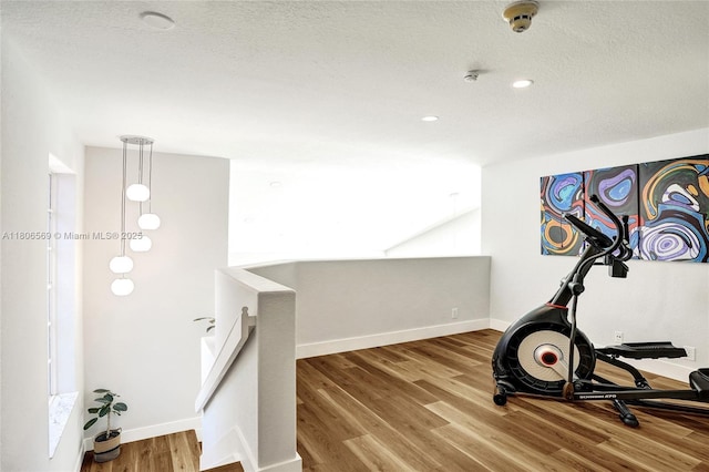 594 Spinnaker, Weston, FL 33326 - workout area featuring wood finished floors, baseboards, recessed lighting, and a textured ceiling