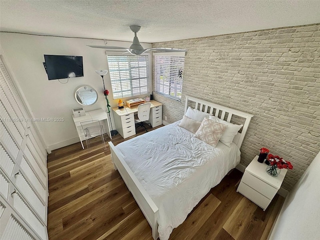 594 Spinnaker, Weston, FL 33326 - bedroom with dark wood-style flooring, a textured ceiling, brick wall, and baseboards