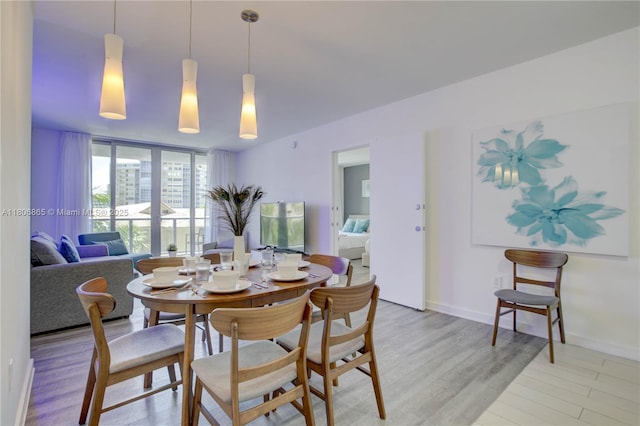 2602 E Hallandale Beach Blvd Unit R407, Hallandale Beach, FL 33009 - dining room featuring light wood-style flooring and baseboards