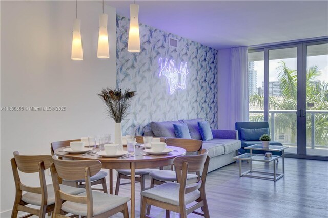 2602 E Hallandale Beach Blvd Unit R407, Hallandale Beach, FL 33009 - dining area featuring wallpapered walls, an accent wall, and wood finished floors
