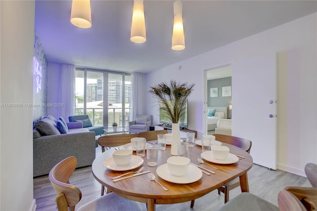 2602 E Hallandale Beach Blvd Unit R407, Hallandale Beach, FL 33009 - dining area with light wood-type flooring and a wall of windows