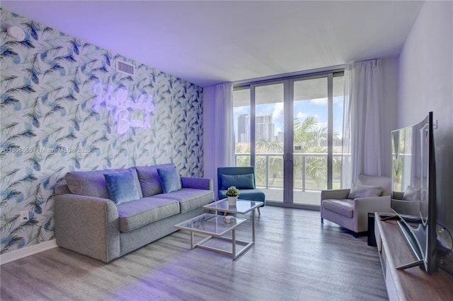 2602 E Hallandale Beach Blvd Unit R407, Hallandale Beach, FL 33009 - living room featuring wallpapered walls, wood finished floors, floor to ceiling windows, an accent wall, and baseboards