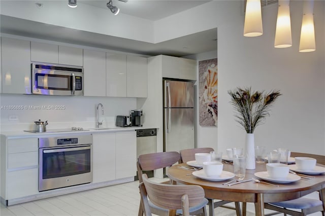 2602 E Hallandale Beach Blvd Unit R407, Hallandale Beach, FL 33009 - kitchen featuring appliances with stainless steel finishes, light countertops, modern cabinets, a sink, and white cabinets