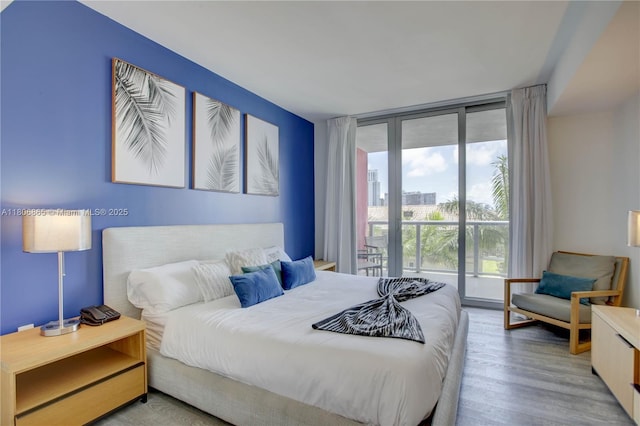 2602 E Hallandale Beach Blvd Unit R407, Hallandale Beach, FL 33009 - bedroom featuring expansive windows, wood finished floors, and access to outside