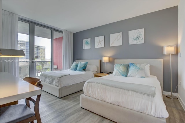 2602 E Hallandale Beach Blvd Unit R407, Hallandale Beach, FL 33009 - bedroom with wood finished floors, access to exterior, french doors, baseboards, and expansive windows