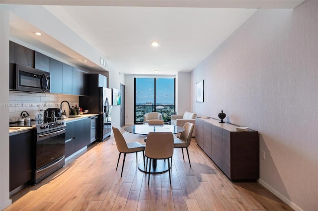 398 NE 5th St Unit 4518, Miami, FL 33132 - dining room with expansive windows and light wood finished floors