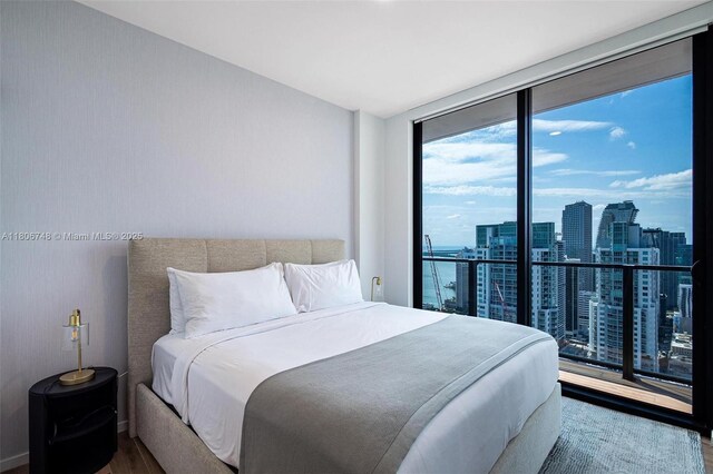 398 NE 5th St Unit 4518, Miami, FL 33132 - bedroom with wood finished floors, a view of city, and expansive windows
