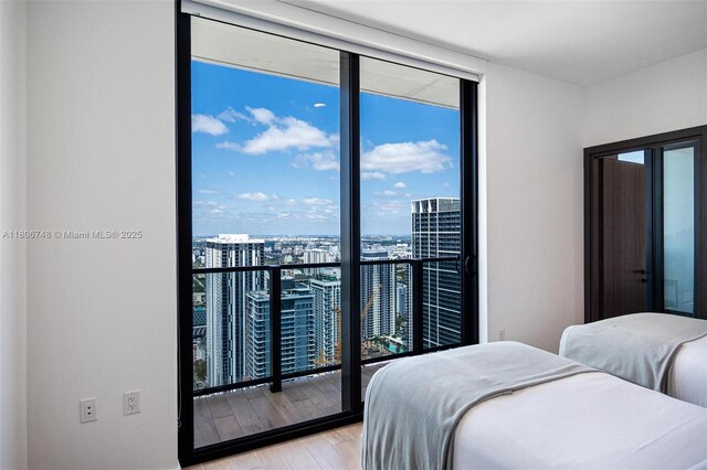 398 NE 5th St Unit 4518, Miami, FL 33132 - bedroom with floor to ceiling windows, a view of city, and light wood-style flooring