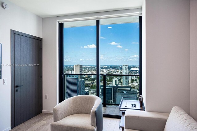 398 NE 5th St Unit 4518, Miami, FL 33132 - sitting room with healthy amount of natural light, wood finished floors, a wall of windows, and a view of city