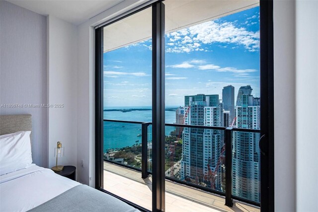 398 NE 5th St Unit 4518, Miami, FL 33132 - bedroom with a view of city, a water view, floor to ceiling windows, and wood finished floors
