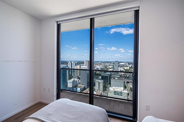 398 NE 5th St Unit 4518, Miami, FL 33132 - bedroom with wood finished floors, a city view, and baseboards