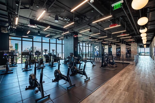 398 NE 5th St Unit 4518, Miami, FL 33132 - workout area featuring a wall of windows and wood finished floors