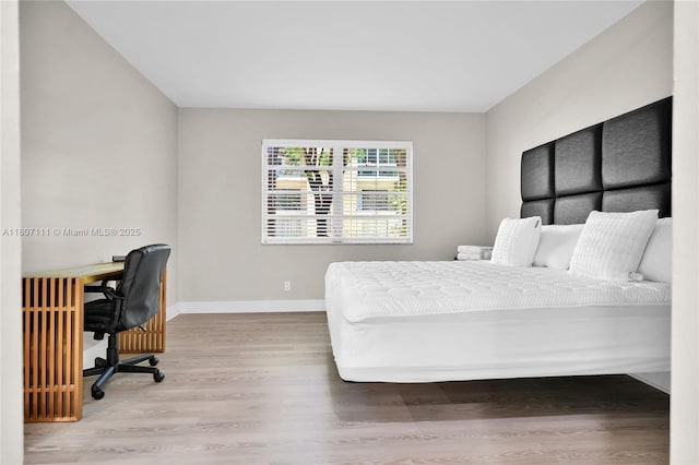 100 Ashbury Rd Unit 103, Hollywood, FL 33024 - bedroom featuring baseboards, wood finished floors, and an office area