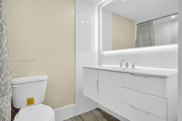 100 Ashbury Rd Unit 103, Hollywood, FL 33024 - full bathroom with toilet, vanity, and wood finished floors