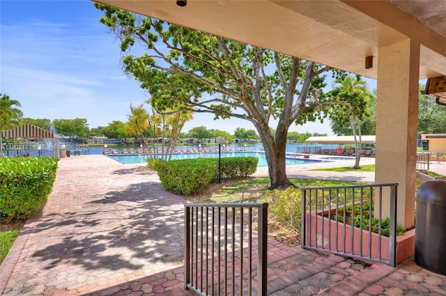 100 Ashbury Rd Unit 103, Hollywood, FL 33024 - view of patio featuring a community pool