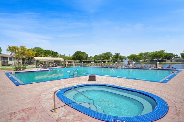 100 Ashbury Rd Unit 103, Hollywood, FL 33024 - community pool with a patio and a community hot tub
