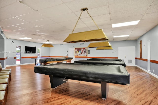100 Ashbury Rd Unit 103, Hollywood, FL 33024 - recreation room with a drop ceiling, wood finished floors, and baseboards