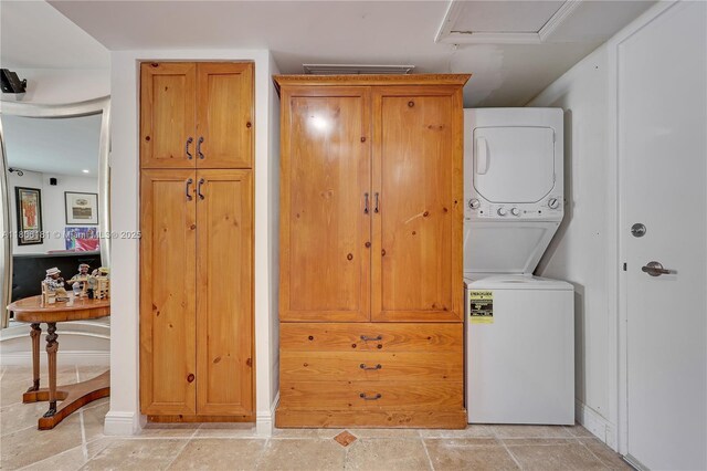 200 Ocean Lane Dr Unit 305, Key Biscayne, FL 33149 - laundry room with stacked washing machine and dryer, baseboards, and attic access