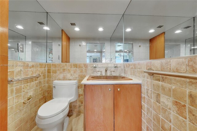 200 Ocean Lane Dr Unit 305, Key Biscayne, FL 33149 - bathroom with toilet, tile walls, and vanity