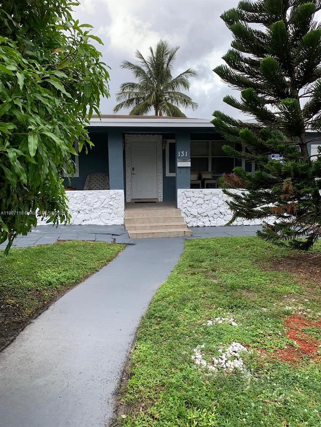 131 Carolina Ave, Fort Lauderdale, FL 33312 - property entrance featuring covered porch and stucco siding