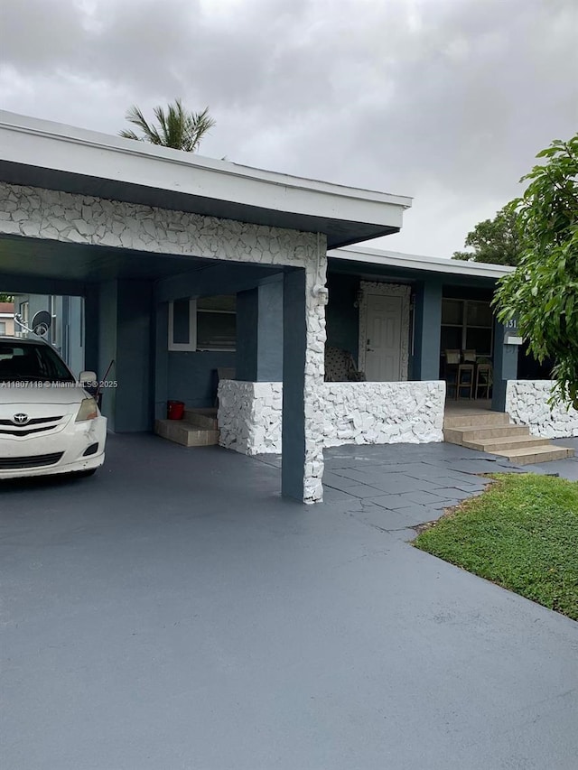 131 Carolina Ave, Fort Lauderdale, FL 33312 - view of front of home featuring stone siding and a carport