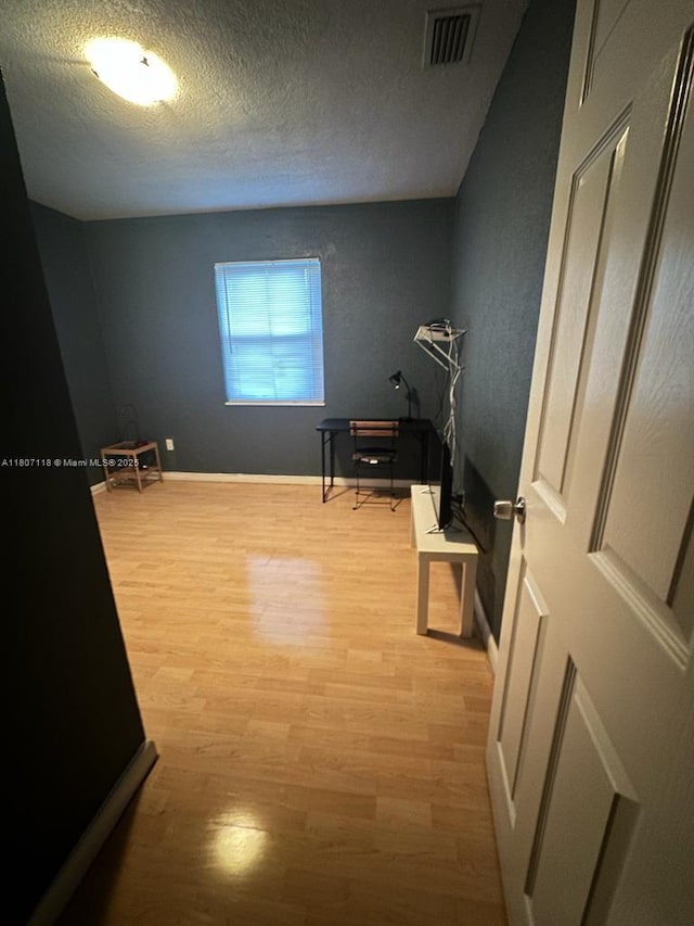131 Carolina Ave, Fort Lauderdale, FL 33312 - bedroom with light wood-style flooring, a textured ceiling, and baseboards