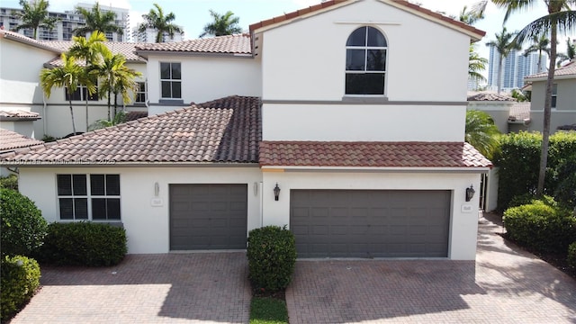 826 E Spinnaker Dr E, Hollywood, FL 33019 - mediterranean / spanish home with stucco siding, a tile roof, decorative driveway, and a garage