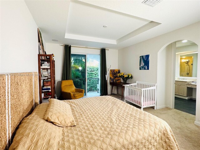 826 E Spinnaker Dr E, Hollywood, FL 33019 - bedroom featuring arched walkways, light carpet, a raised ceiling, and access to outside
