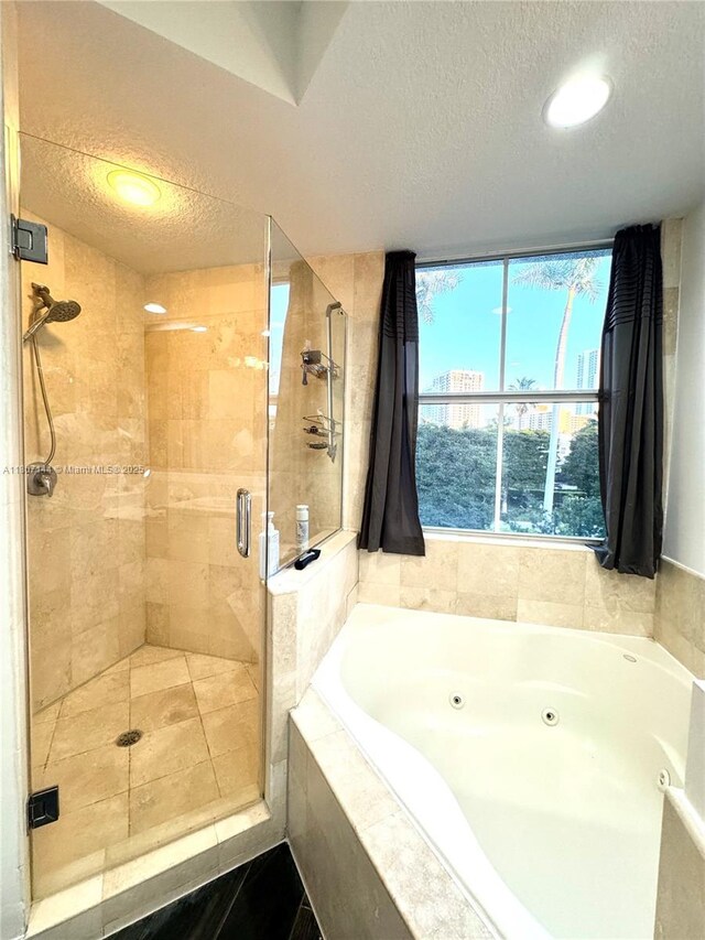 826 E Spinnaker Dr E, Hollywood, FL 33019 - full bath with a textured ceiling, a tub with jets, and a shower stall