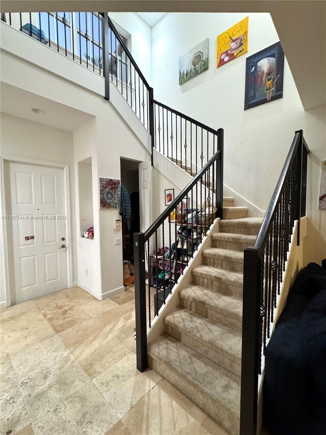 826 E Spinnaker Dr E, Hollywood, FL 33019 - staircase with a towering ceiling and baseboards