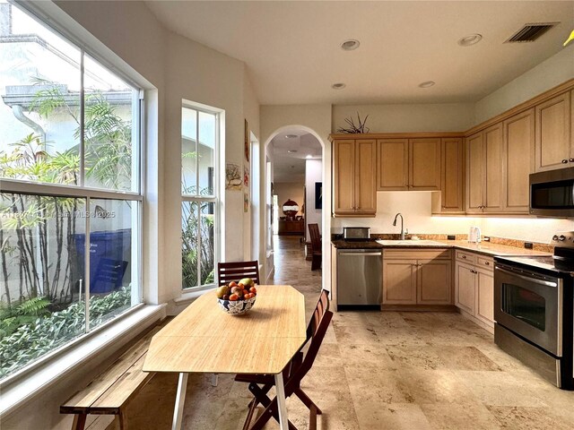 826 E Spinnaker Dr E, Hollywood, FL 33019 - kitchen with appliances with stainless steel finishes, arched walkways, recessed lighting, and a sink