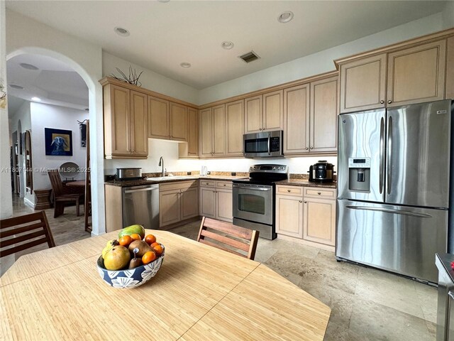 826 E Spinnaker Dr E, Hollywood, FL 33019 - kitchen with stainless steel appliances, arched walkways, a sink, and recessed lighting