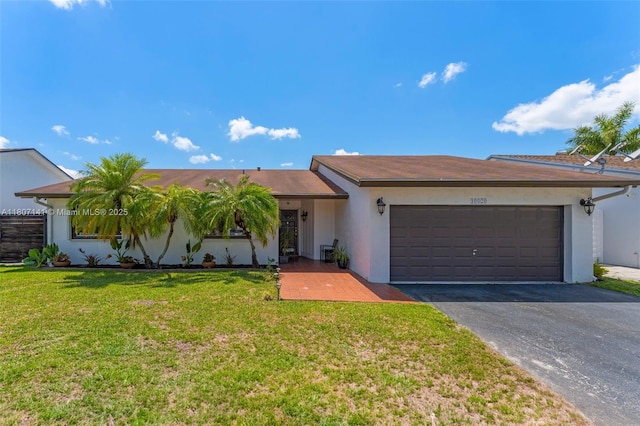 10020 SW 145th Pl, Miami, FL 33186 - ranch-style home with a garage, driveway, stucco siding, and a front yard