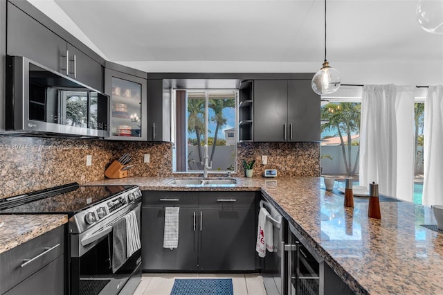 10020 SW 145th Pl, Miami, FL 33186 - kitchen with appliances with stainless steel finishes, stone countertops, decorative backsplash, open shelves, and light tile patterned floors