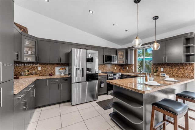 10020 SW 145th Pl, Miami, FL 33186 - kitchen with open shelves, stainless steel appliances, lofted ceiling, a peninsula, and tasteful backsplash