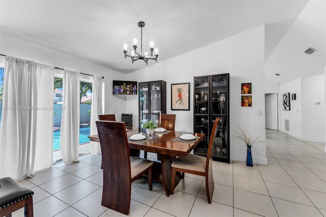 10020 SW 145th Pl, Miami, FL 33186 - dining space with vaulted ceiling, a chandelier, and light tile patterned floors