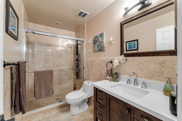 10020 SW 145th Pl, Miami, FL 33186 - bathroom with vanity, tile walls, a stall shower, tile patterned flooring, and wainscoting